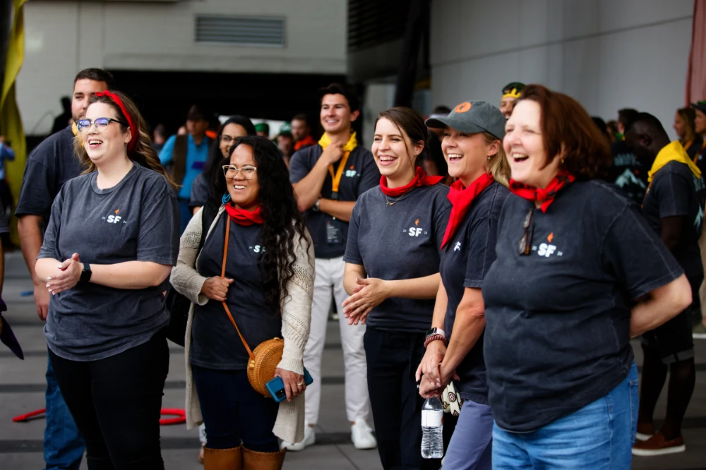 SunFire employees celebrate during a team-building activity during a company retreat.